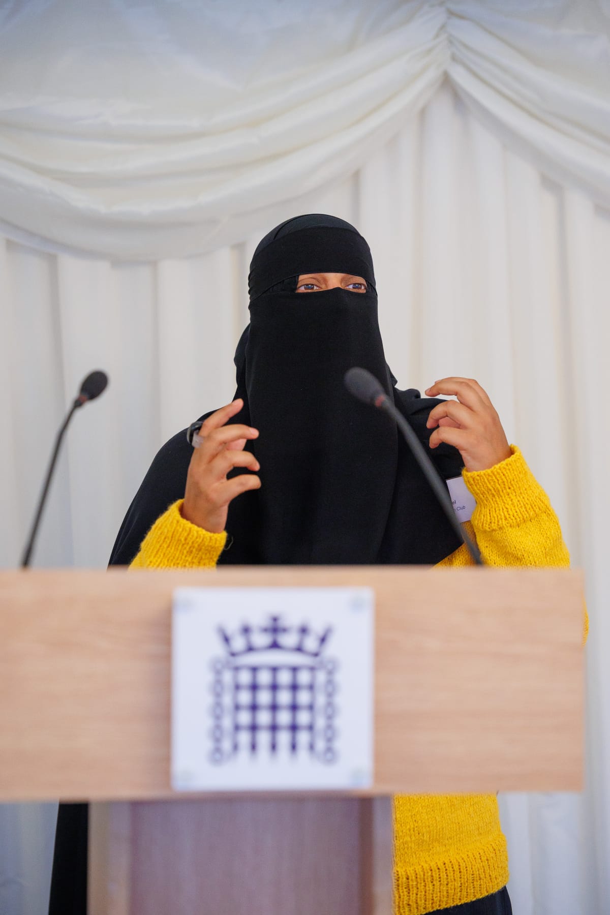 Khadija Patel speaking behind a lecturn.