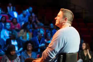 Man presenting to a crowd.
